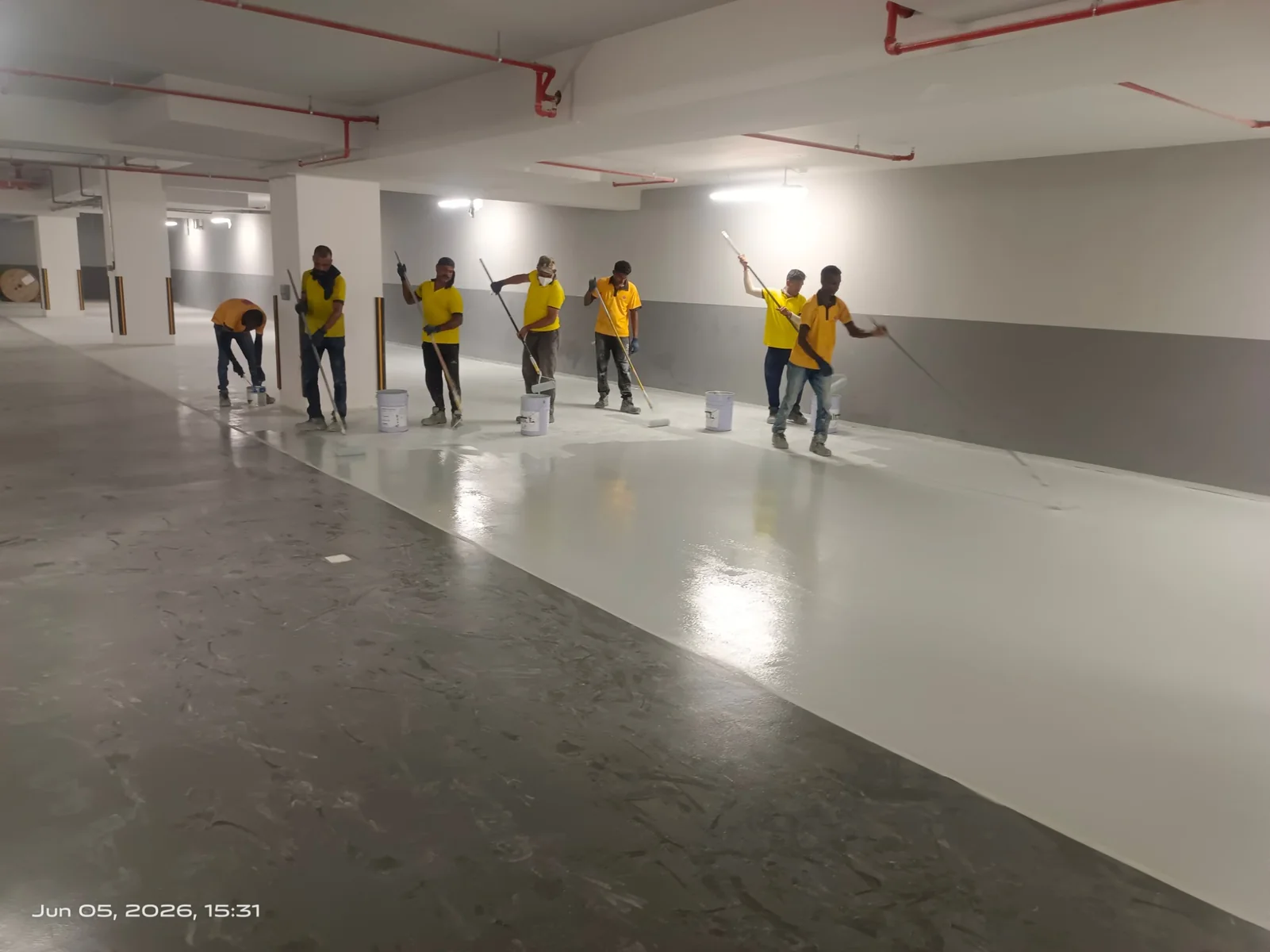Commercial epoxy flooring application in a parking and utility area